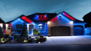 A residence decorated with striking red, white, and blue lights on the exterior, showcasing a celebratory ambiance.