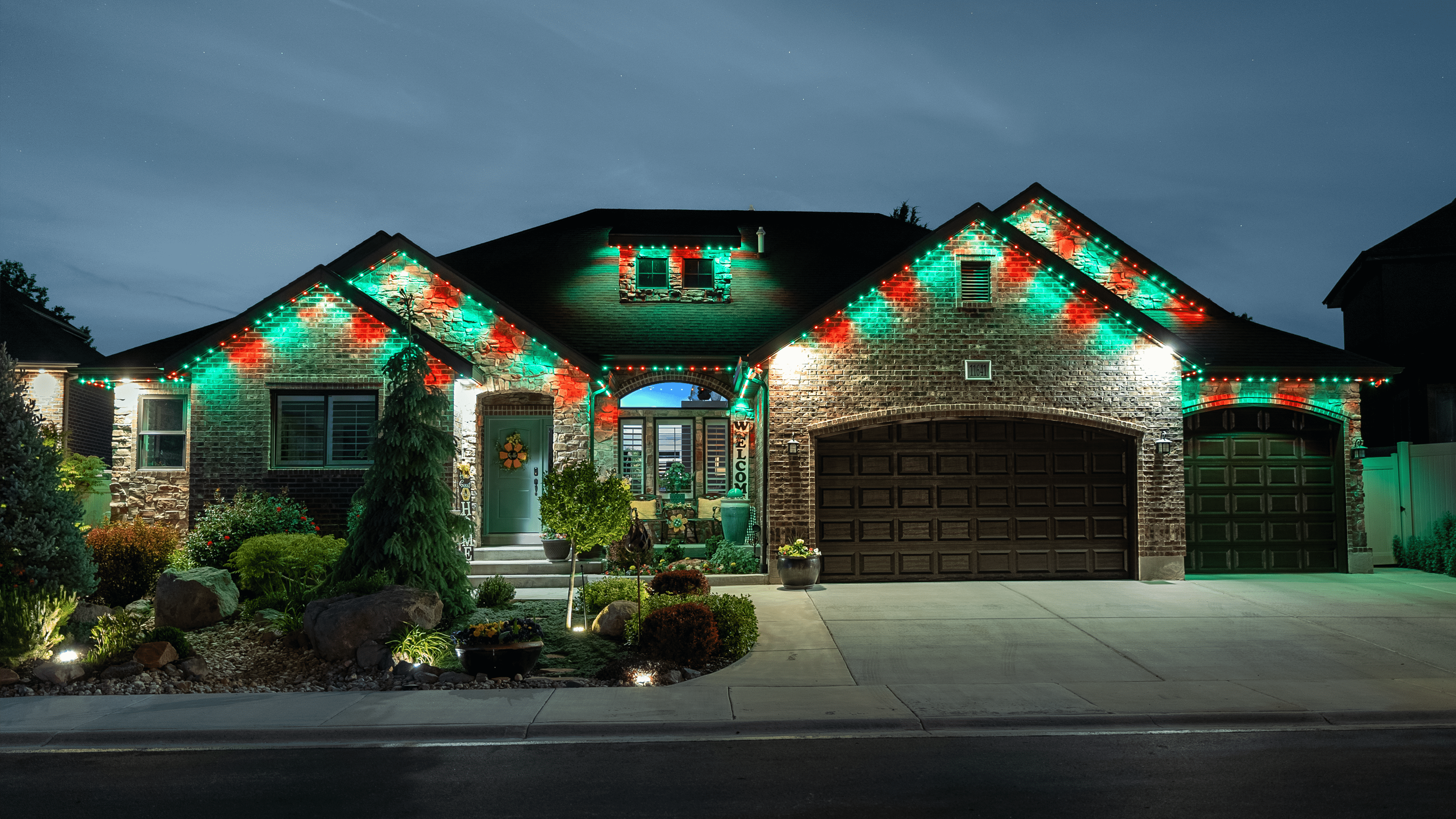 A festive house illuminated with Christmas lights on the front and side, exemplifying the creativity of Chameleon Lighting.