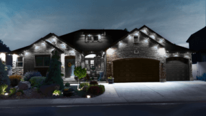 A cozy home illuminated by lights along the driveway, creating a warm and inviting atmosphere in the evening.